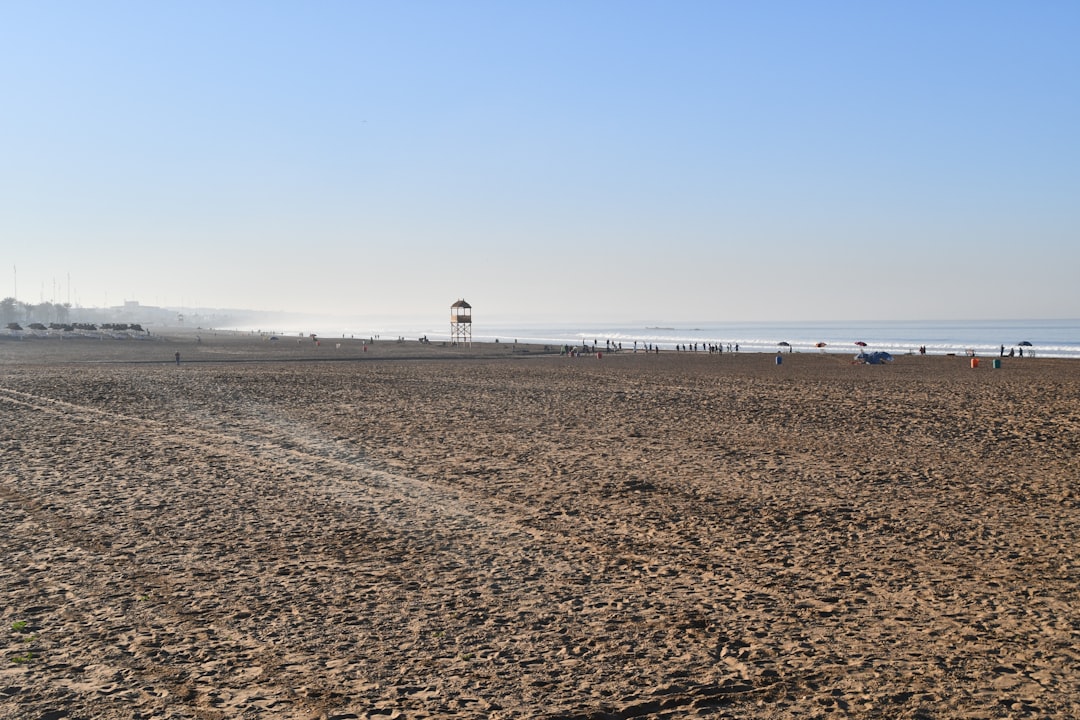 A Guide to Exploring Agadir in Morocco 2 a sandy beach with people walking on it