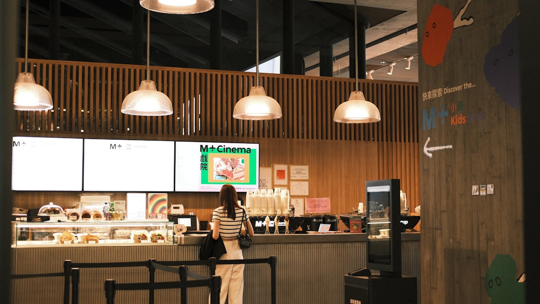 A woman standing in front of a counter in a restaurant