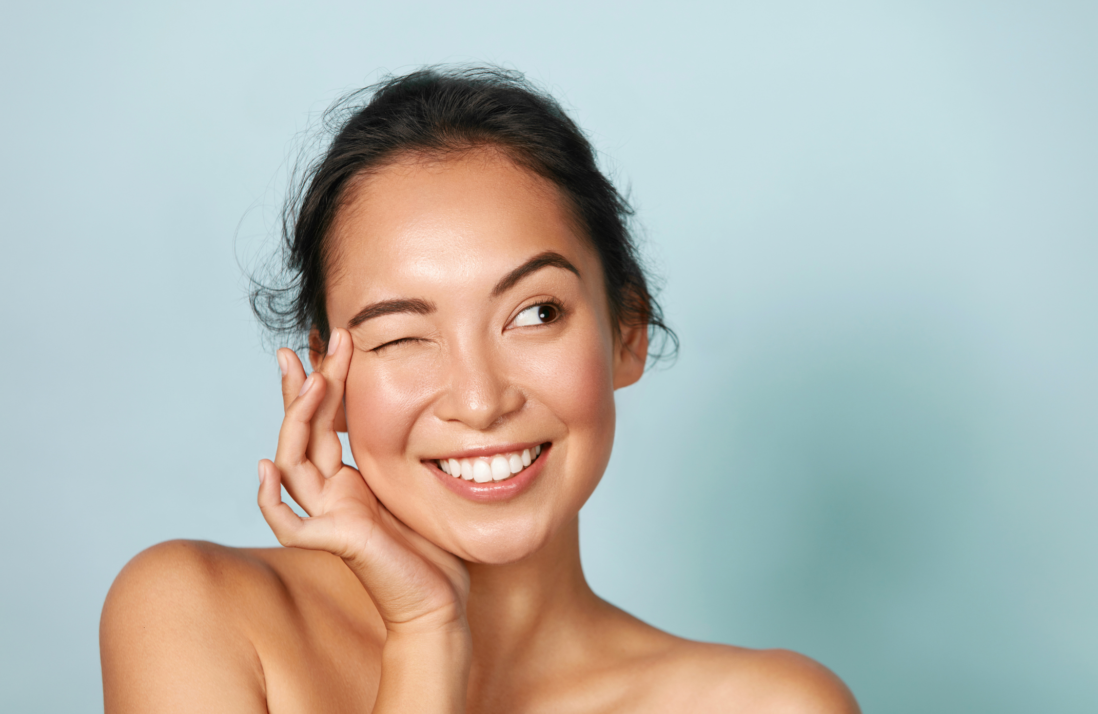 young beautiful girl blinking with one eye, radiant skin with Beauty with Ceramides – 60 Vegicaps KIKI HEALTH