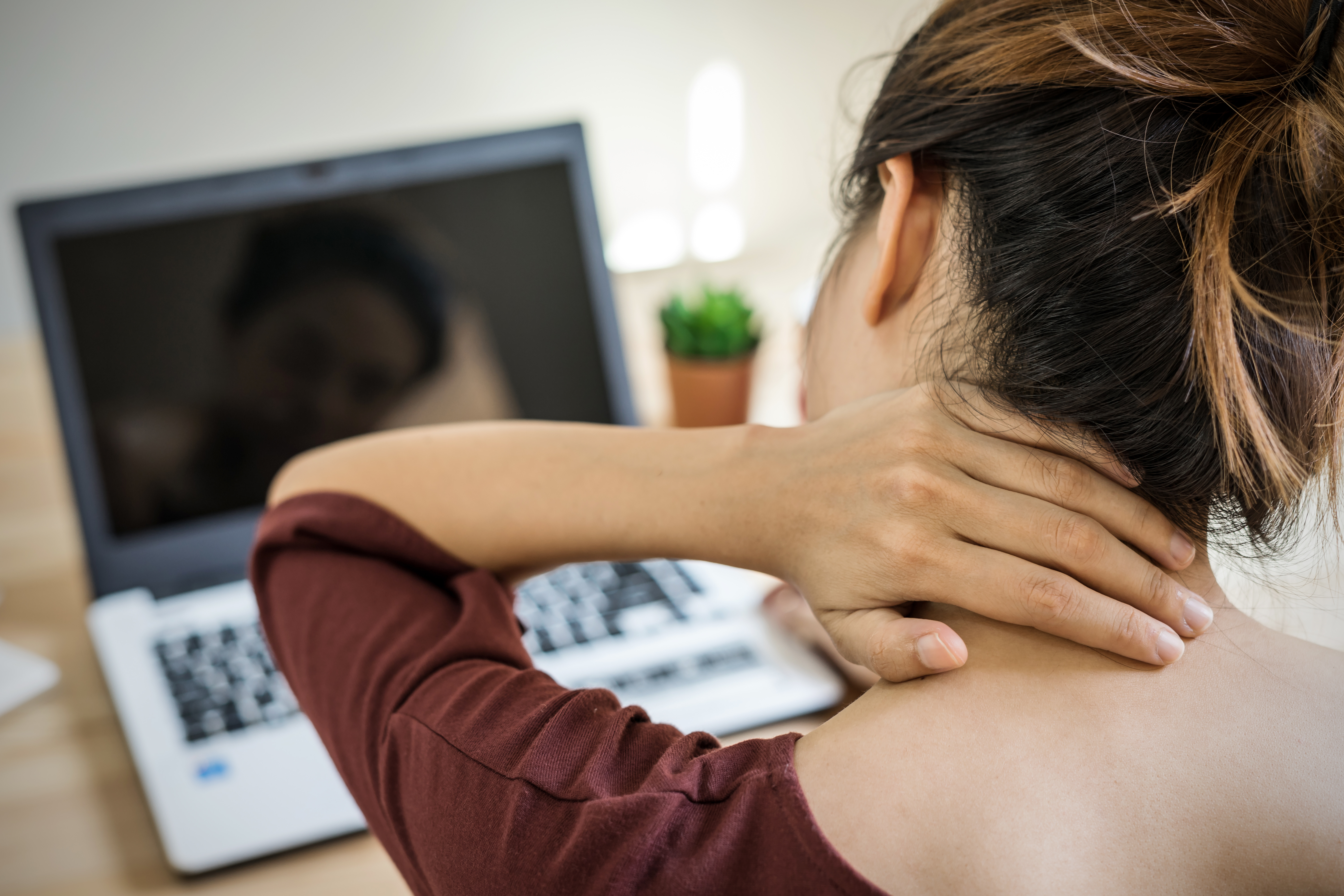 Woman holding neck during work