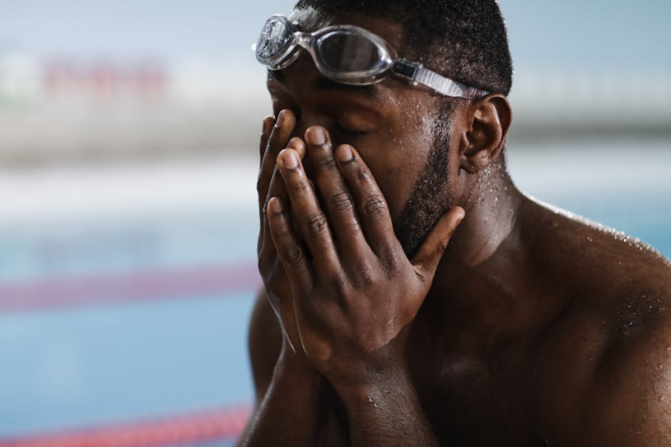 A Swimmer Hands on His Face